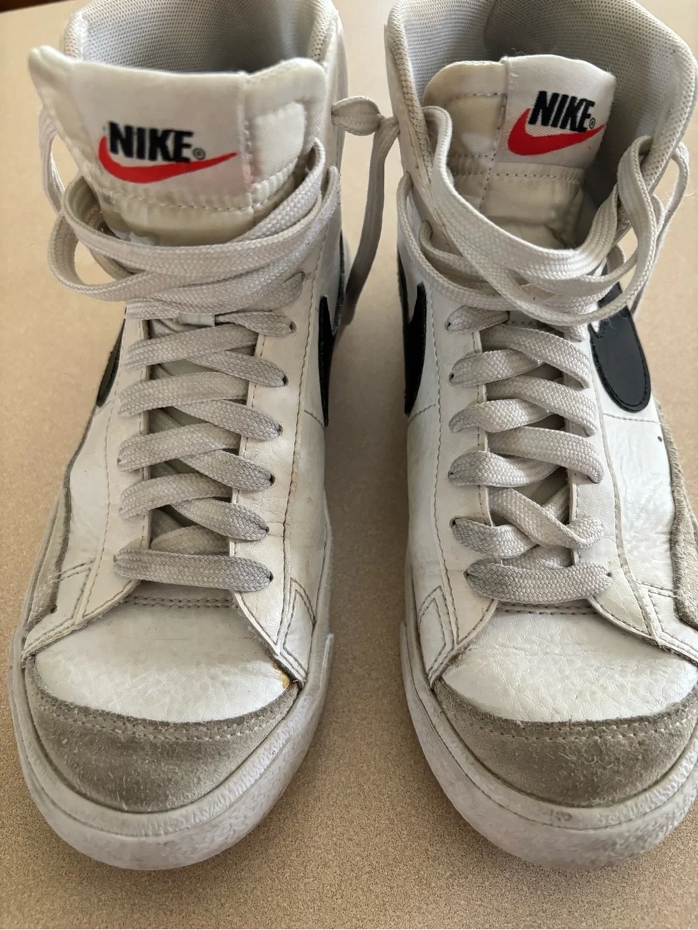 Nike Women’s White and Black High-Top Sneakers with Iconic Swoosh
